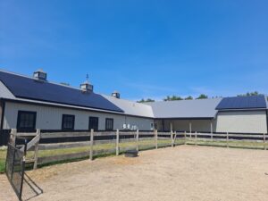 Commercial solar panel installation on a horse barn roof in Rochester, MA, designed and installed by Brightstar Solar for a local agricultural business in Plymouth County.