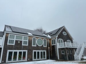 Residential solar panel installation in Southborough, MA with snow.