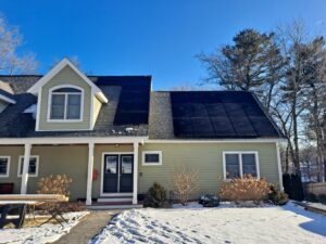 Residential solar panels shedding snow in Andover, MA.