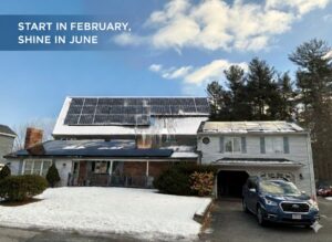 Residential solar panel installation by Brightstar Solar in Tewksbury, MA, featuring a snow-covered roof with high-efficiency panels